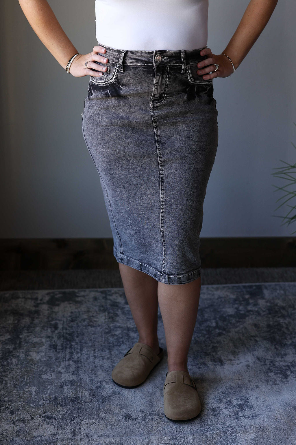 Enhance your denim skirt collection with this Black Mineral Heavy Stitching Denim Skirt. The mineral wash adds a fun touch to the classic black color, while the heavy stitching details elevate the overall look. A must-have for any denim skirt wardrobe. Classy Closet online women's clothing boutique for denim midi skirts and modest fashion.