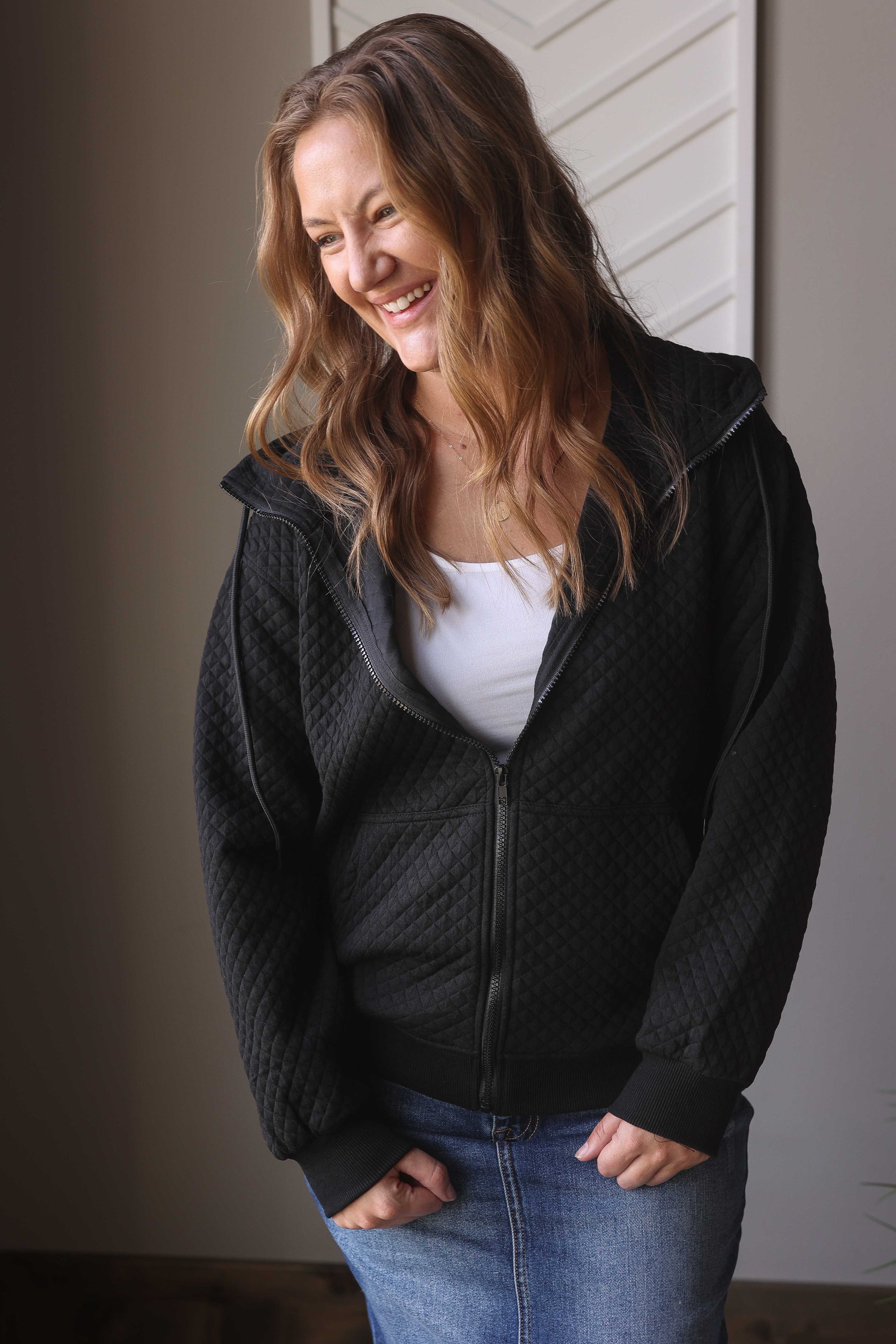 Introducing our Black Quilted Zipper Jacket, the perfect versatile addition to your wardrobe. With a cute quilted texture, convenient pockets, and a cozy hood, this solid black jacket is sure to meet all your needs. Stay stylish and comfortable all day long. Classy Closet everyday women's clothing boutique for modest trendy fashion.