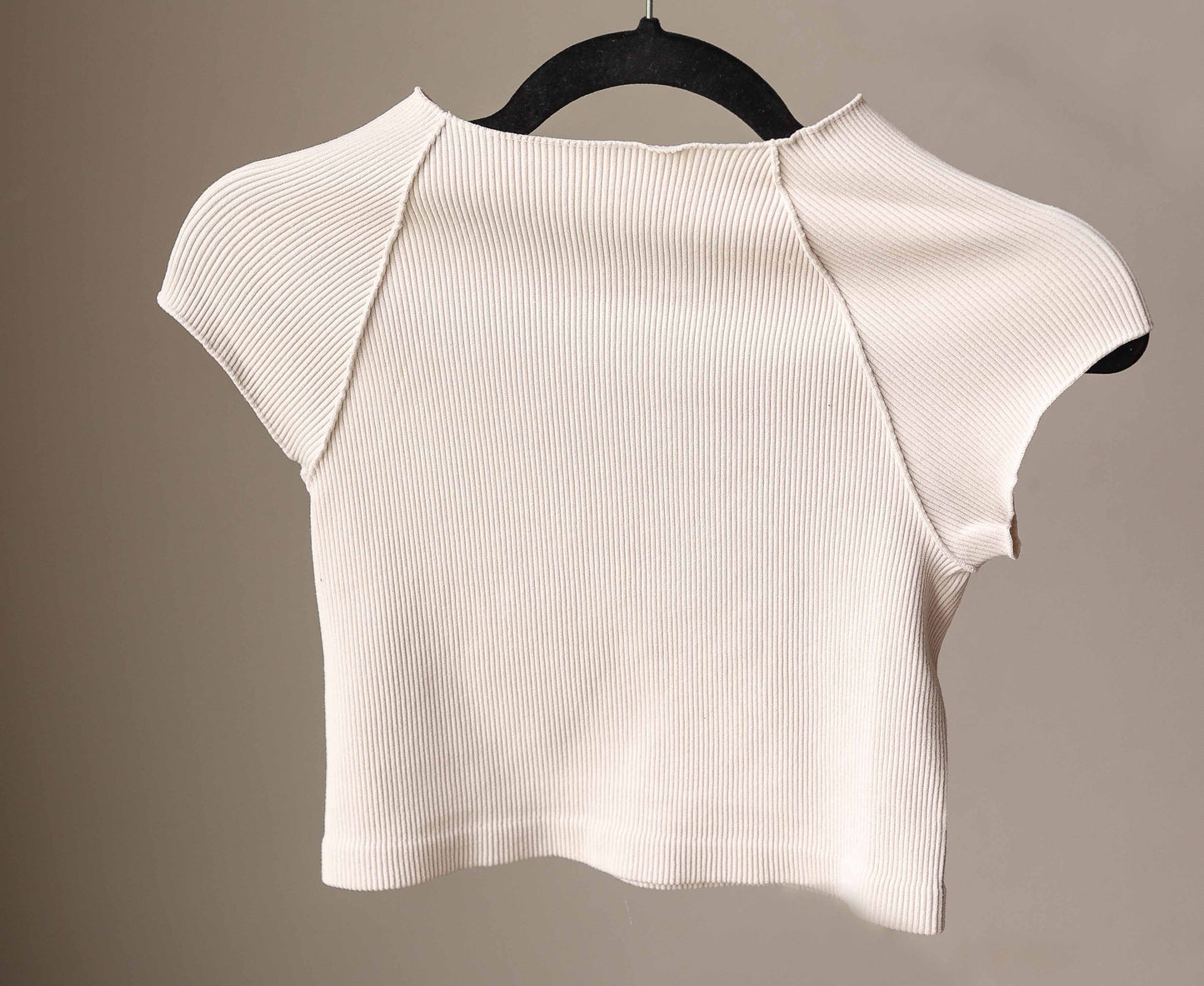 This Sand Beige Ribbed Short Sleeve Half Tee is designed for comfort and style. Its ribbed, stretchy fabric offers a snug, fitted look that layers effortlessly without adding bulk. Perfect for nursing moms too!