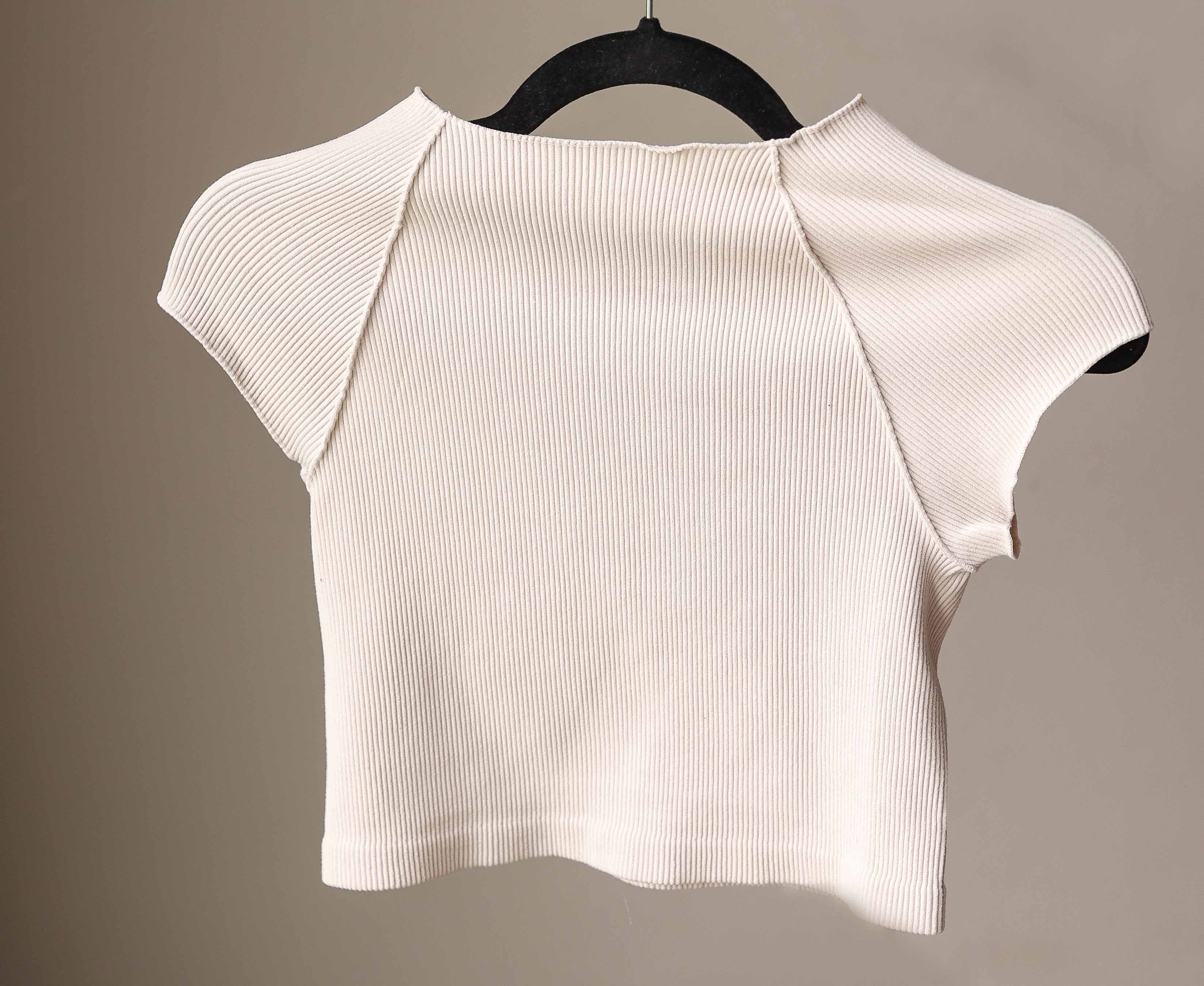 This Sand Beige Ribbed Short Sleeve Half Tee is designed for comfort and style. Its ribbed, stretchy fabric offers a snug, fitted look that layers effortlessly without adding bulk. Perfect for nursing moms too!