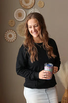 Woman wearing Black Drop Shoulder Pocket Crewneck Sweatshirt with relaxed fit, casual style perfect for everyday comfort for spring outfits