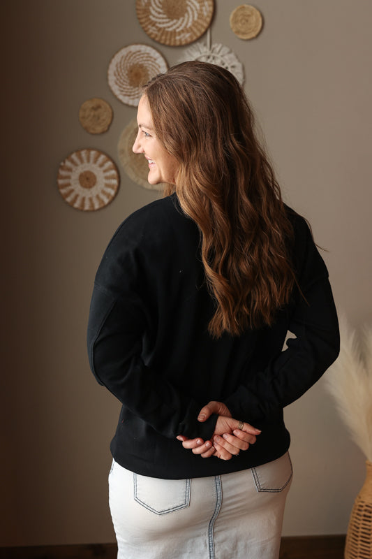 Woman wearing Black Drop Shoulder Pocket Crewneck Sweatshirt with relaxed fit, casual style perfect for everyday comfort for easy spring style