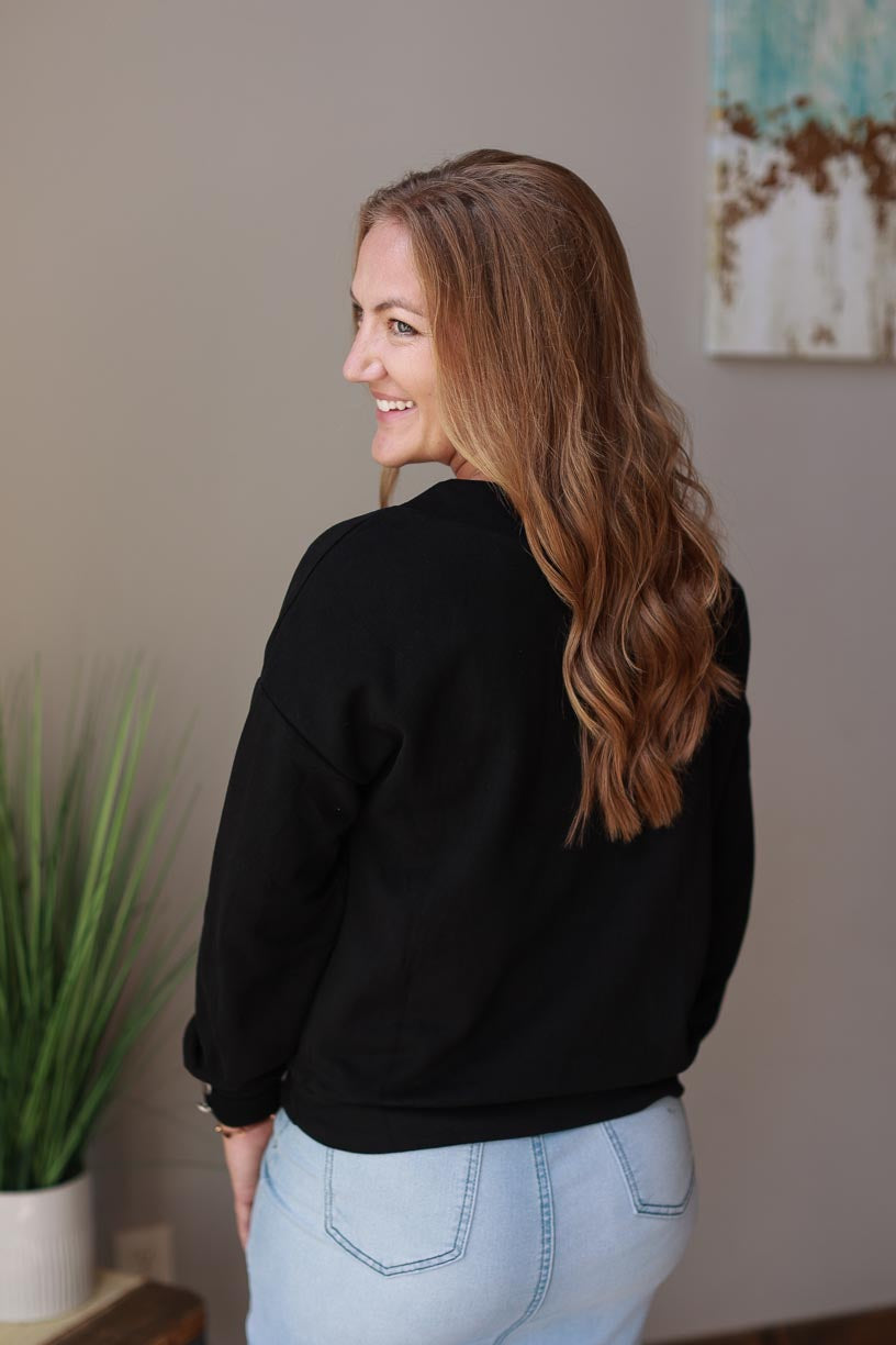 This classic black V-neck sweatshirt is the perfect blend of comfort and style. Made from a mid-weight, breathable fabric, this top is perfect for heading to work or date night effortlessly. The S-2XL PLUS sizing ensures comfortable fit for many body types. Invest in timeless quality and style with this essential top.