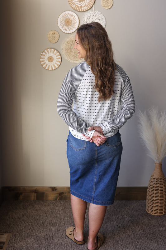 Black stripe raglan sleeve top shown with a comfortable relaxed fit for everyday wear