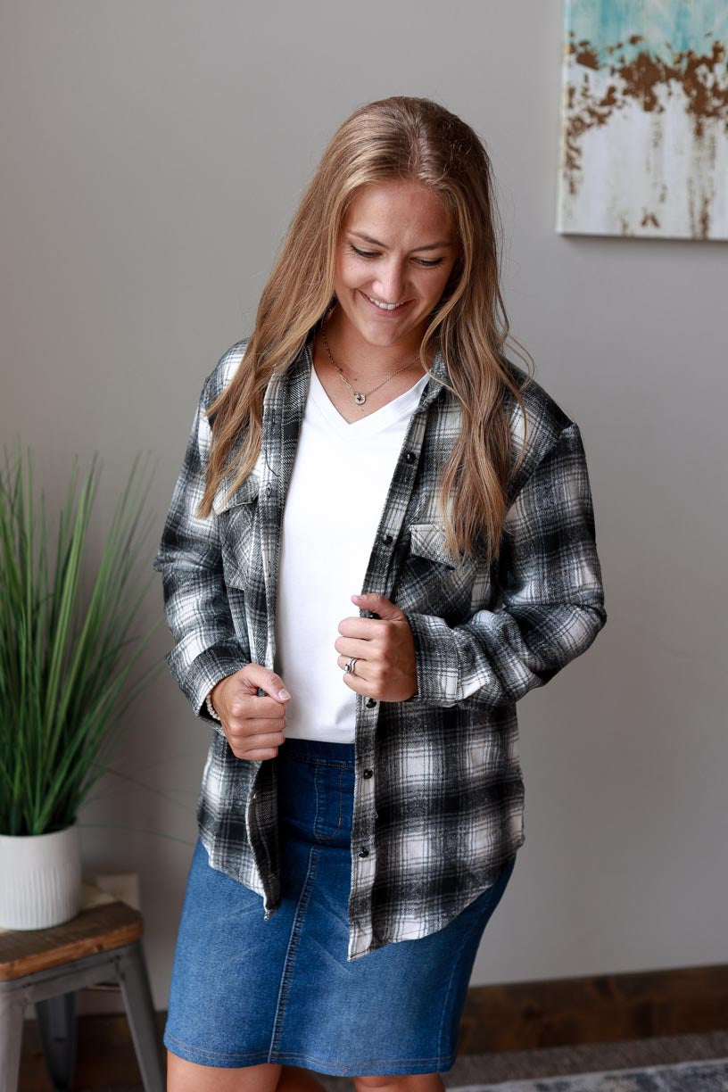 This classic flannel top is perfect for any season. The black, white, and grey color scheme will complement any outfit, while the cozy flannel fabric helps keep you warm. at Classy Closet Online Women's Boutique Near Me