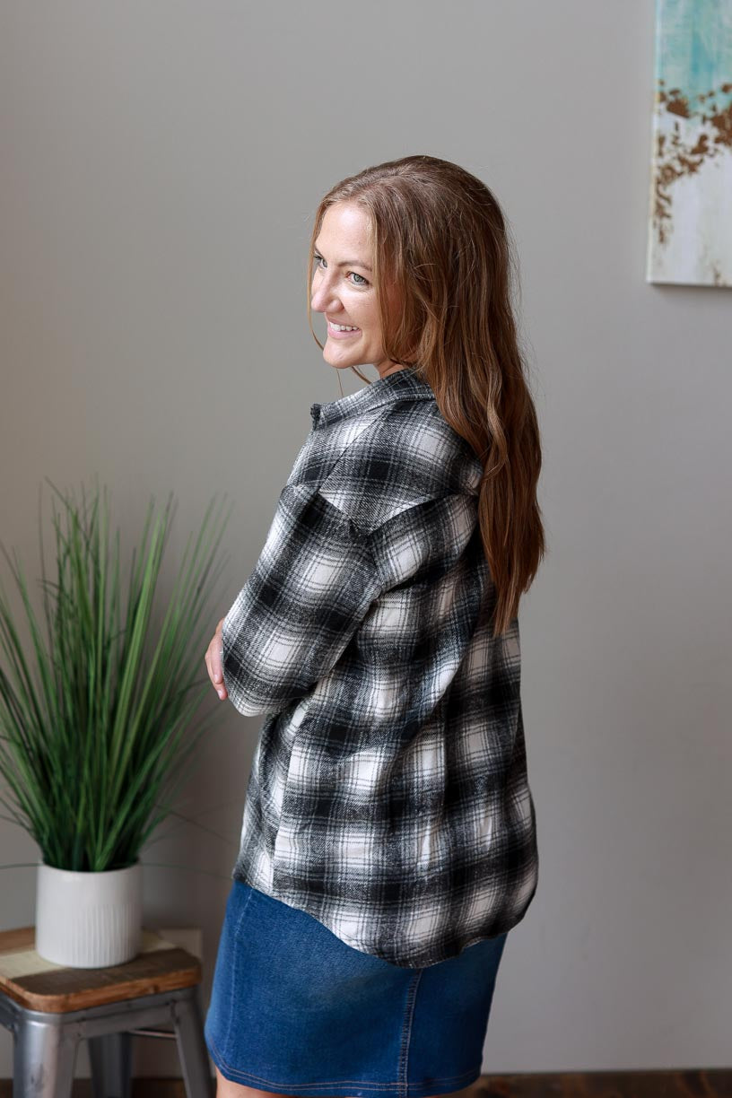 This classic flannel top is perfect for any season. The black, white, and grey color scheme will complement any outfit, while the cozy flannel fabric helps keep you warm. at Classy Closet Online Women's Boutique Near Me