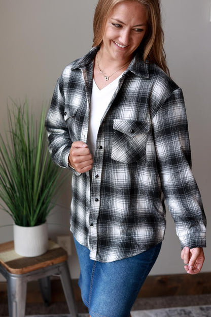 This classic flannel top is perfect for any season. The black, white, and grey color scheme will complement any outfit, while the cozy flannel fabric helps keep you warm. at Classy Closet Online Women's Boutique Near Me