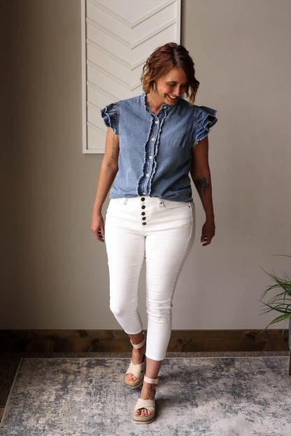The Blue Ruffle Sleeve Denim Shirt is a chic and versatile addition to your summer wardrobe. With cute ruffle sleeves and button front details, this shirt pairs well with any colored bottoms for multiple stylish looks. Stay effortlessly on-trend this season!