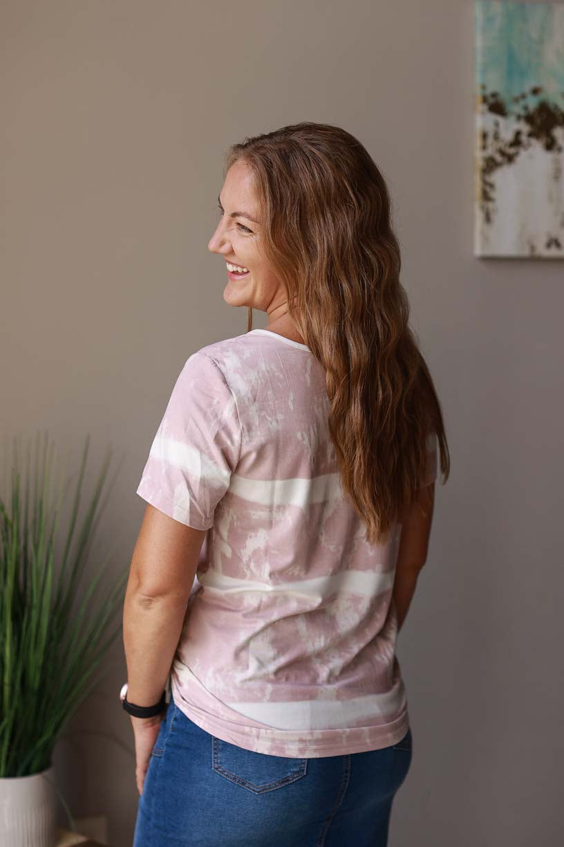 This blush tie dye Henley top makes casual mom life look good! Made from soft and stretchy material, it offers a classic fit and a cozy touch of fun. Women's Clothing Boutique Online for Modest Fashion at Classy Closet