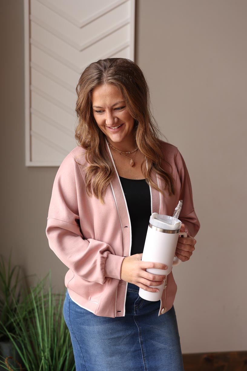 Stay stylish and cozy with our Pink V-Neck Button Knit Cardigan. The perfect transition piece for any season, it features a touch of varsity style. Whether you're heading to work or keeping it casual, pair it with a graphic tee and sneakers for an effortless and trendy look. Classy Closet online women's clothing boutique for cute, affordable outfits and modest fashion. 