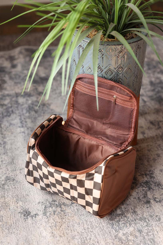 Stay organized and trendy with our Brown Checkered Makeup Bag. This versatile bag is perfect for on-the-go touch ups and also doubles as a travel essential for all your vacation needs. Upgrade your makeup routine with this super cute and functional bag. Classy Closet online modest women's clothing boutique for stay at home moms, teachers, office styles.