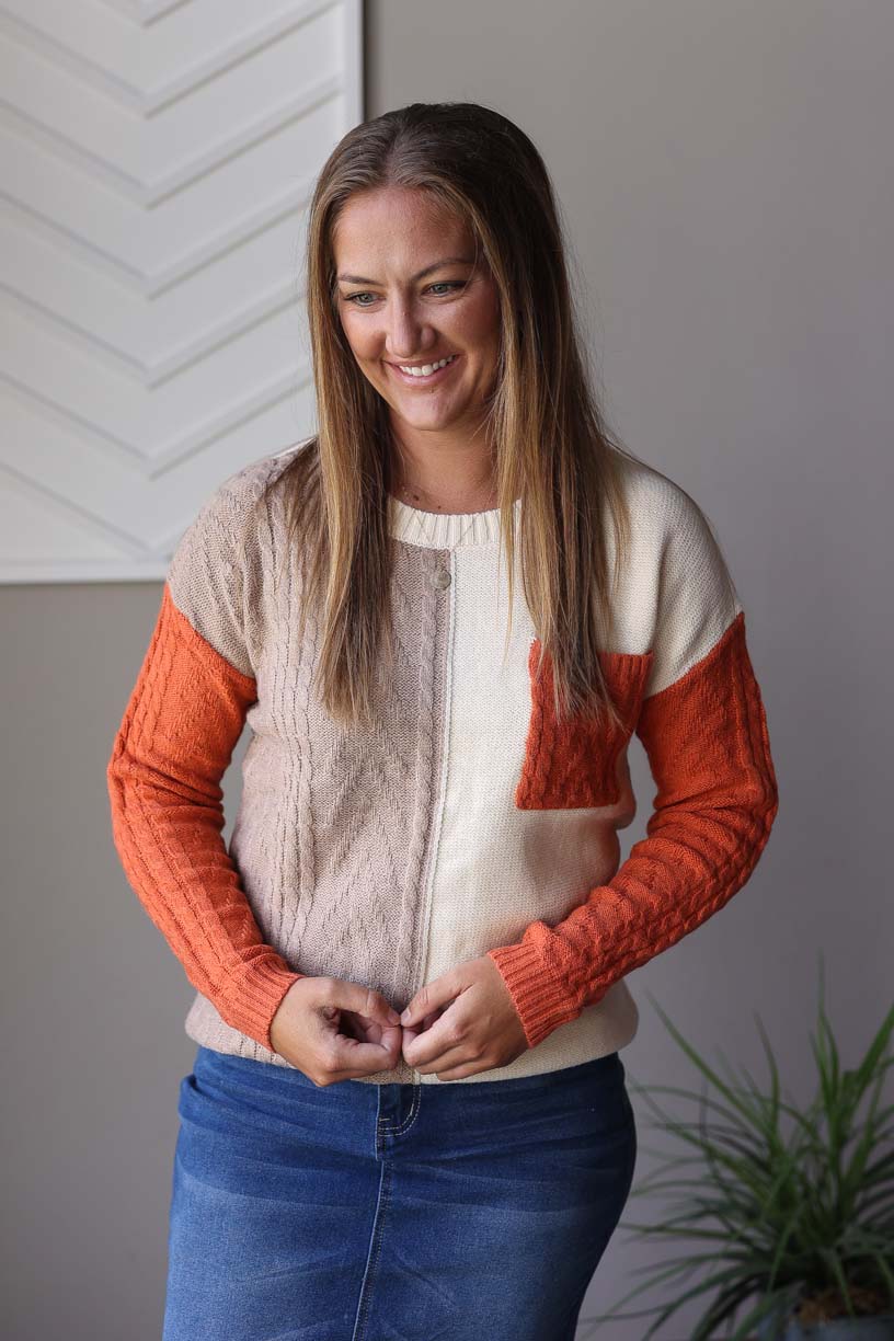 Get ready for fall with our Rust Colorblock Sweater! Made with a cute and versatile design, this sweater is perfect for any occasion. With its mix of cream, brown, and rust colors and cable knit texture, it's easy to style for teachers, office wear, or date nights. Look and feel great this season with this must-have piece!