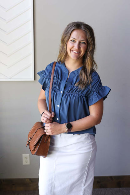 Elevate your style with this adorable teal button-up blouse! Perfect for date nights, weddings, or office wear, this lightweight top features ruched details and ruffle short sleeves. The rich dark blue-teal color adds a nautical touch while keeping your look polished and versatile. Dress it up or down for different occasions!