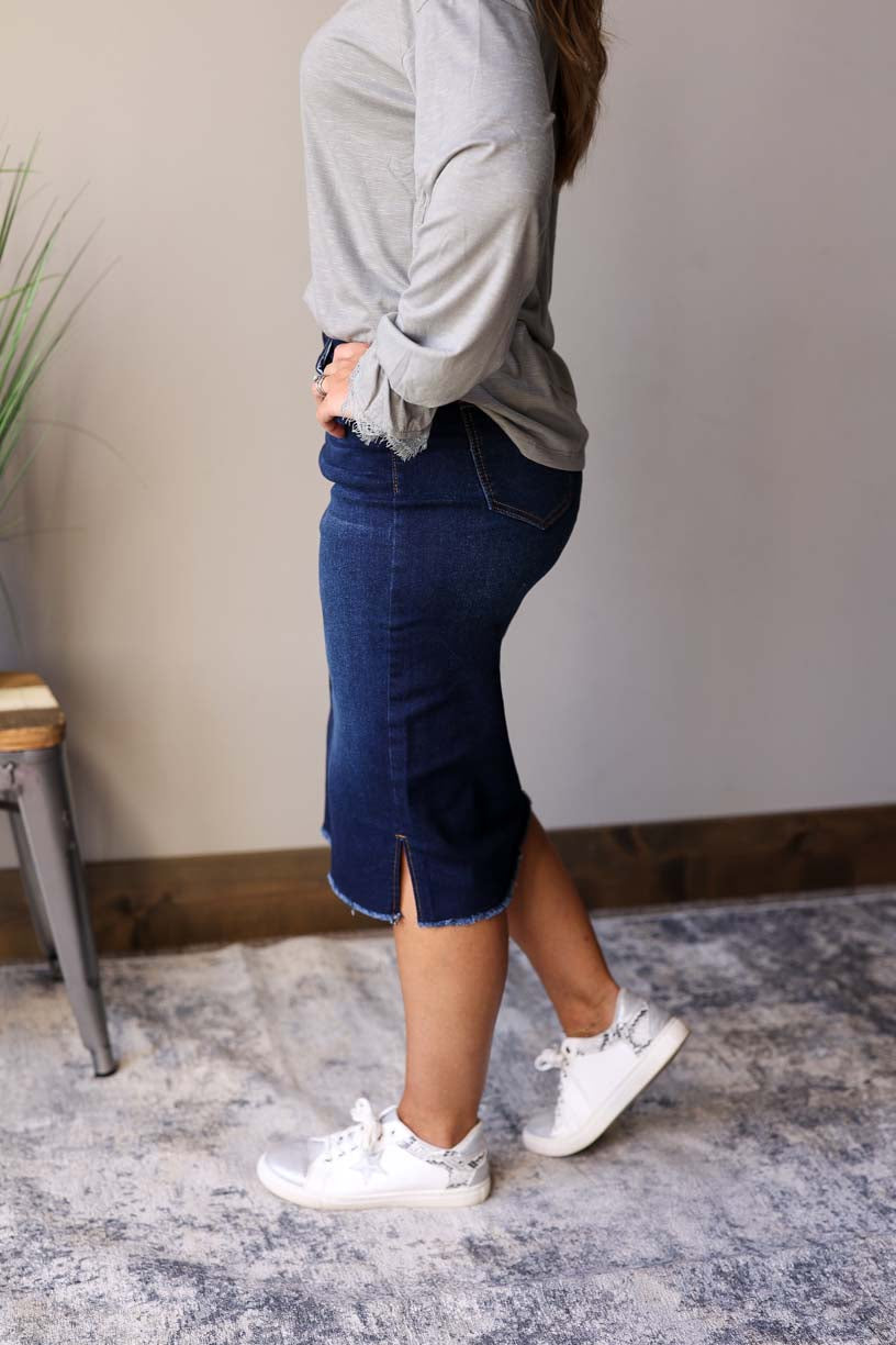 Becca Dark Wash Side Slit Denim Skirt. This stylish jean skirt features a dark wash for a sleek and sophisticated look that you can wear to work, school, or date night for fall winter outfits.