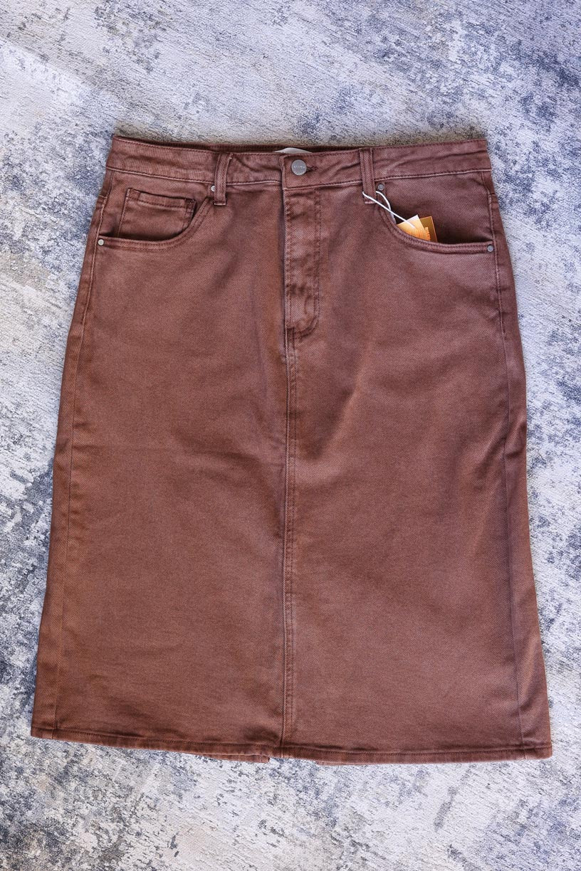 Look stylish in this espresso-colored RISEN Denim Skirt- perfect for any outfit. Features include a back slit and comfort fit for all day wear. Feel stylish and comfortable with this must-have wardrobe denim skirt.