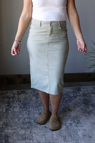 Add a pop of color to your wardrobe with our Fern Green Denim Midi Skirt. This subtle yet stylish skirt effortlessly adds a touch of modesty to any outfit. Perfect for a happy and simple look. Classy Closet online women's clothing boutique for hard to find midi skirts and modest trendy fashion.