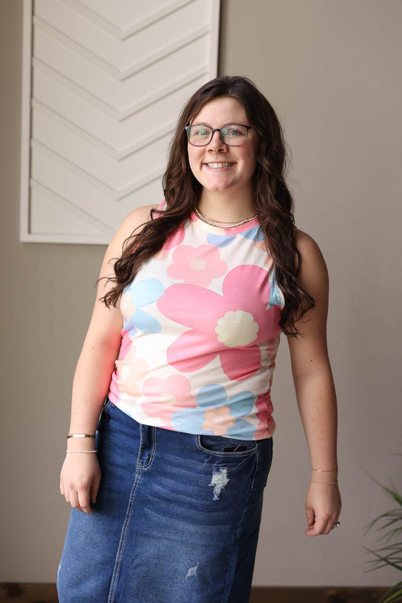 Summer days are about to get brighter with our Pink Floral Sleeveless Top. The wide straps and fun floral print, chosen by our "be the buyer" winner, make this top a must-have for any stylish trip to the park or zoo. Elevate your summer wardrobe with this customer favorite. Classy Closet online boutique for women's modest apparel in Rock Valley iowa