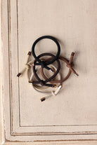 Elevate your hair game with our 5pc Camel Elastic Knotted Hair Ties! These trendy "bracelets" are not only functional but also add a fun accessory to your wrist. Perfect for a stylish look on the go, you or your girls will love the cute details. Get yours now! Classy Closet is a women's clothing boutique for everyday functional style and denim skirts. 