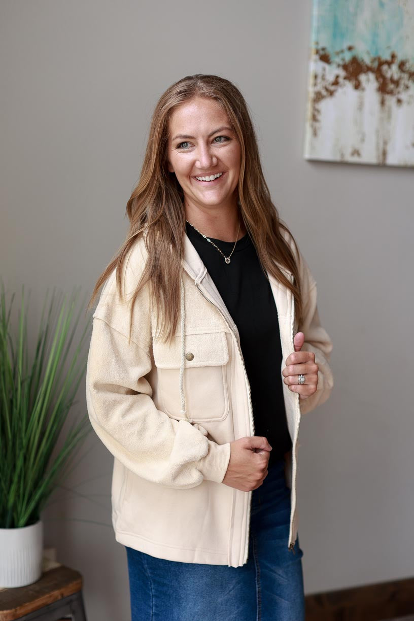 Ivory Hooded Zip Up Jacket. Made with ivory two-tone fabric with a drawstring hood, this jacket ensures maximum coziness and a timelessly trendy look. Beat the chill in style and keep cozy all season long! Classy Closet WOmen's Boutique Near Me