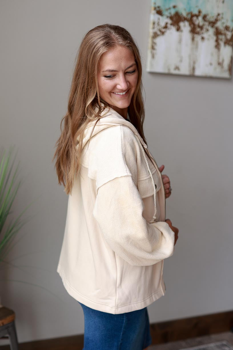 Ivory Hooded Zip Up Jacket. Made with ivory two-tone fabric with a drawstring hood, this jacket ensures maximum coziness and a timelessly trendy look. Beat the chill in style and keep cozy all season long! Classy Closet WOmen's Boutique Near Me