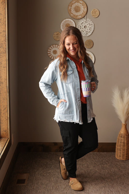 Cozy chestnut orange hooded top paired with casual winter or spring basics like black cargo joggers and a light wash denim shirt
