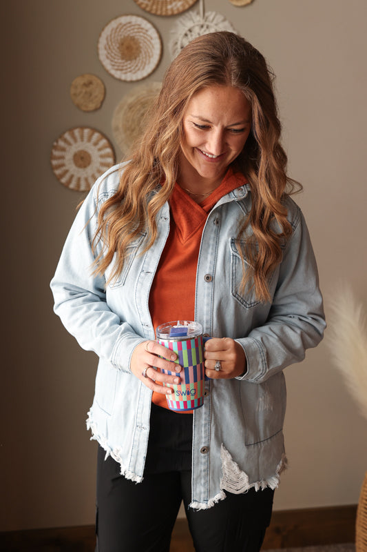 Modest chestnut orange hooded top with colorblock sleeves worn as an everyday outfit under a denim shirt