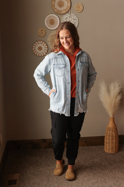Sky blue fray hem denim shirt jacket styled for casual mom life with black cargo joggers