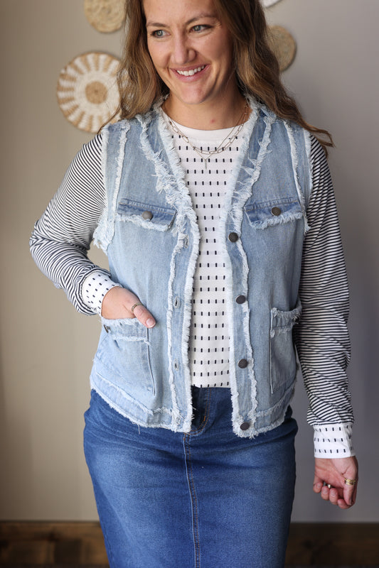 Frayed edge flap pocket denim vest jacket paired with a modest outfit