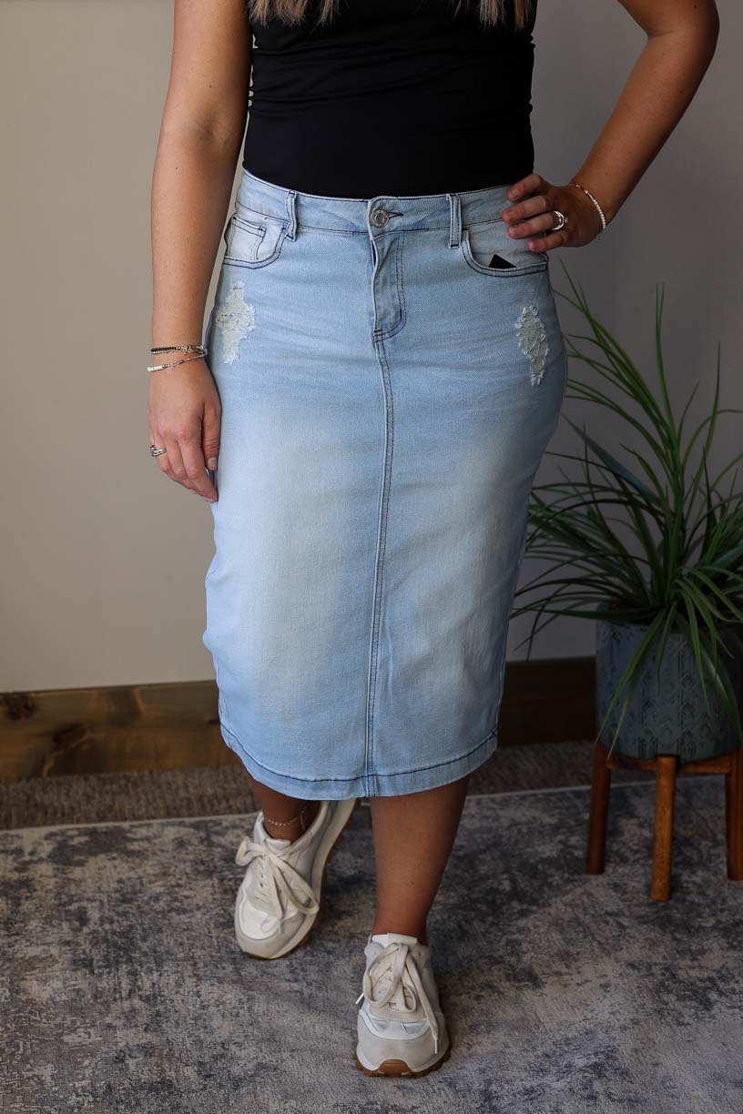 Introducing the Abby Light Wash Distressed Denim Skirt, your new go-to piece for effortless style and comfort. The light wash color and slight distressing add a trendy touch, while the heavy stitching and stretchy denim offer a perfect fit. Update your wardrobe today! Classy Closet shop for women's modest denim skirts and hard to find knee length jean skirts.