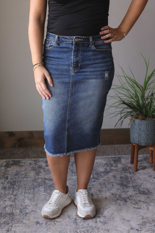 Introducing our new favorite style, the Nicole Mid Wash Distressed Knee Length Denim Skirt! With a perfect length and stretchy design, this skirt offers both comfort and style. The minimal distressing adds just the right amount of edge, while the pockets and back slit provide functionality. Classy Closet modest denim skirts for women