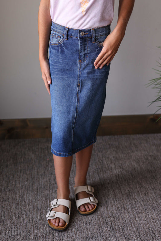 This Medium Wash Midi Denim Skirt is made to grow with her—classic, comfy, and ready for everyday fun at home or school.

Medium wash denim with a timeless look [*Create a mommy &amp; me match with the womens version we have of this one too!]

Adjustable waist inserts for a custom, comfy fit

Midi length for modest and easy wear

Durable fabric made for active days

Pairs effortlessly with any top for endless outfit options