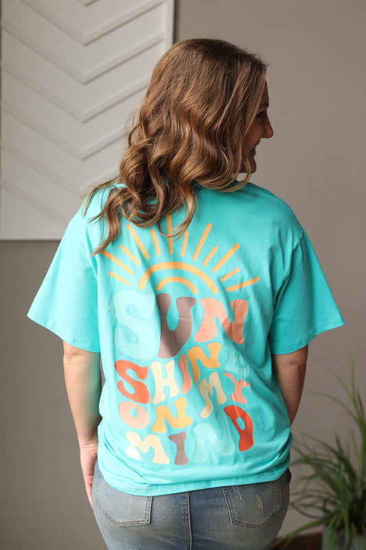 This oversized and comfy mint blue tee is perfect for summer days spent at the beach, pool, lake, or just hanging out in the backyard with the kids! With a fun graphic of "sunshine on my mind" on the back, this unique tee is sure to bring a smile to your face. Classy Closet Modest Clothing Boutique