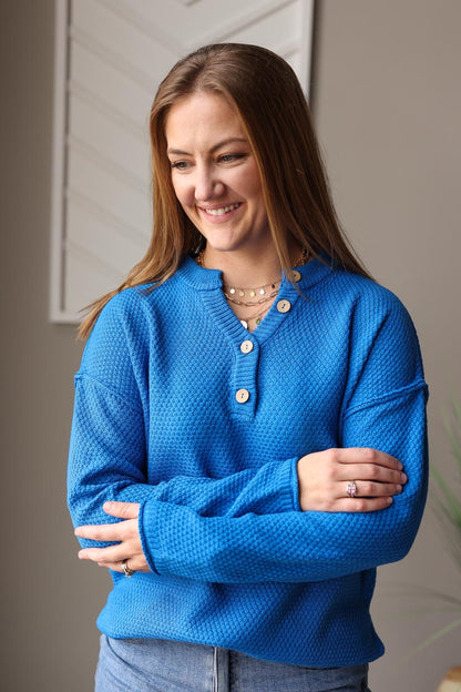 Ocean Blue Henley Sweater, the perfect addition to your cold weather wardrobe. Brighten up any day with this cheerful blue sweater, featuring stylish henley details and a breathable knit material. Effortlessly update your everyday looks, whether for work or play. Classy Closet Online Women's BOutique for Cute Casual Winter Outfits in Iowa
