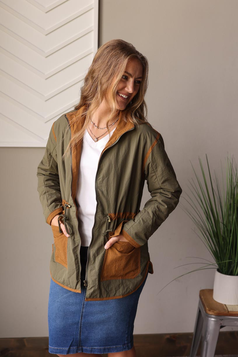 Olive Quilted Jacket, a must-have for your fall winter wardrobe. This mid-weight stunner features cute chestnut pocket and trim details, complete with a drawstring waist function for the perfect fit.  Classy Closet Online Women's CLothing Boutique for Modest Fashion