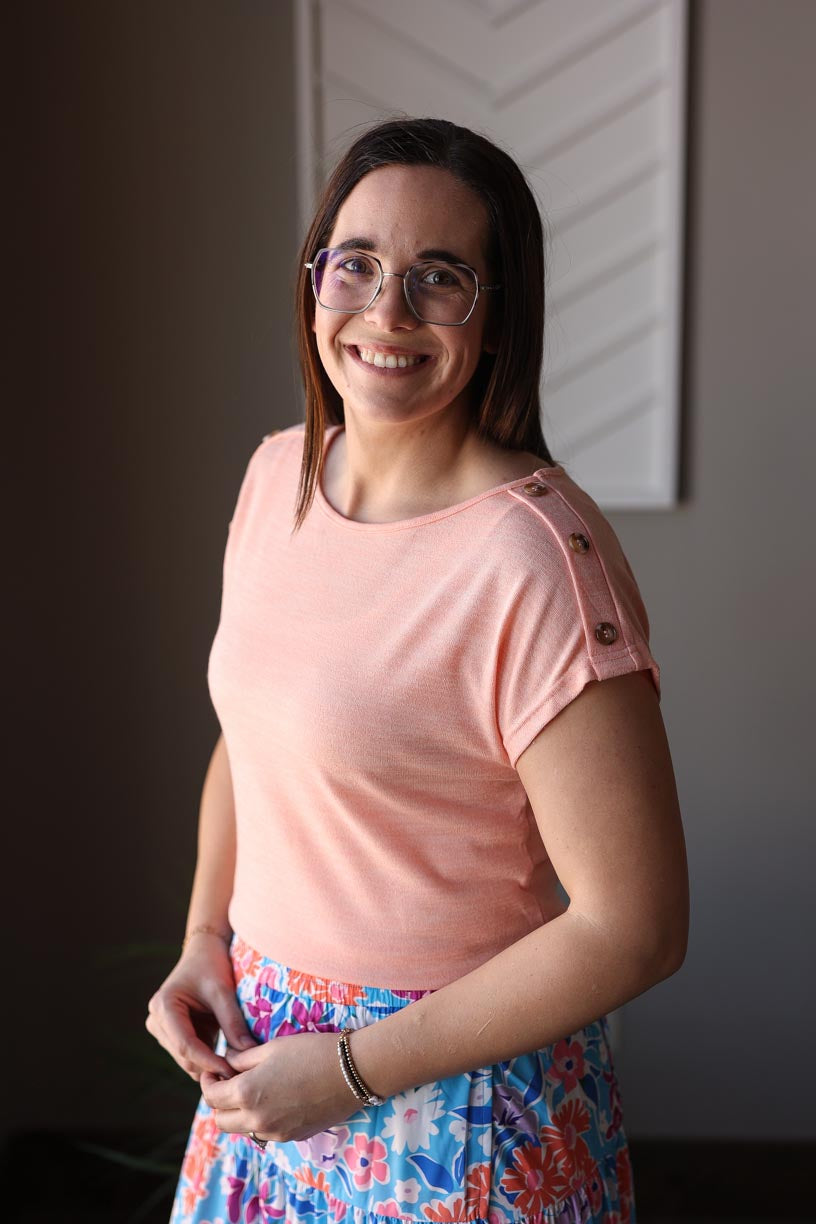 Stylish and effortless, our Coral Button Detail Tee is perfect for spring and summer. With its soft and lightweight material, you can comfortably wear it all day at work, home, or out with friends. Complete the look with our Blue Floral Wrap Maxi Skirt. Classy Closet Boutique Hull Iowa