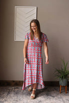 Introducing our Red V-Neck Floral Maxi Dress - a fun, cheerful dress perfect for all your summer adventures. Made with a lightweight fabric and a convenient snap closure on the v-neck, it's also a great option for nursing moms! Dress it up or down for any occasion. Classy Closet nursing friendly summer dress 
