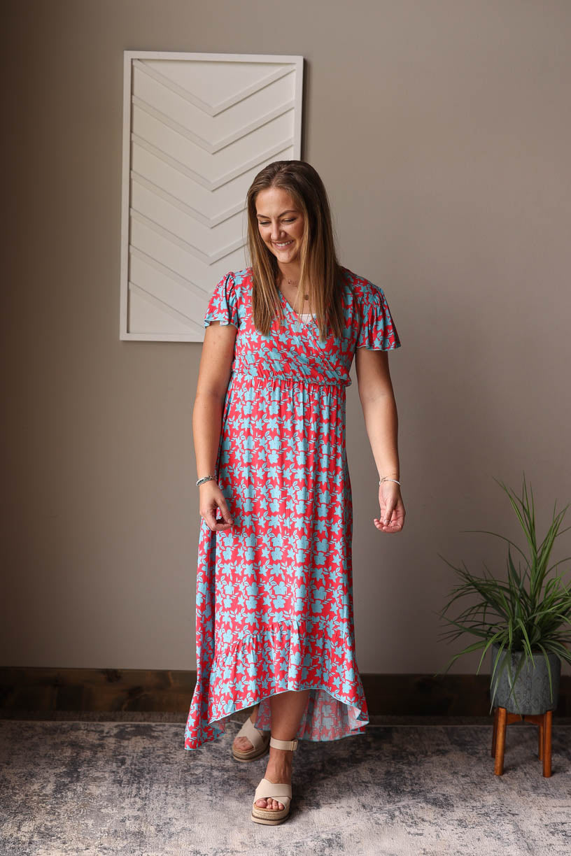 Introducing our Red V-Neck Floral Maxi Dress - a fun, cheerful dress perfect for all your summer adventures. Made with a lightweight fabric and a convenient snap closure on the v-neck, it's also a great option for nursing moms! Dress it up or down for any occasion. Classy Closet nursing friendly summer dress 