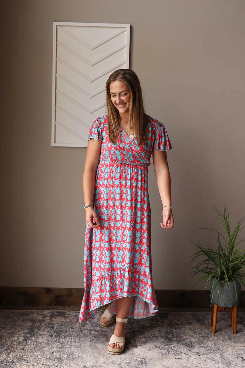 Introducing our Red V-Neck Floral Maxi Dress - a fun, cheerful dress perfect for all your summer adventures. Made with a lightweight fabric and a convenient snap closure on the v-neck, it's also a great option for nursing moms! Dress it up or down for any occasion. Classy Closet nursing friendly summer dress 