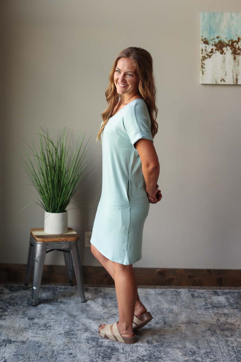 Front view of sage green v-neck  summer midi dress with rolled up sleeves, perfect for everyday summer casual style at Classy Closet, a women's online modest boutique store.