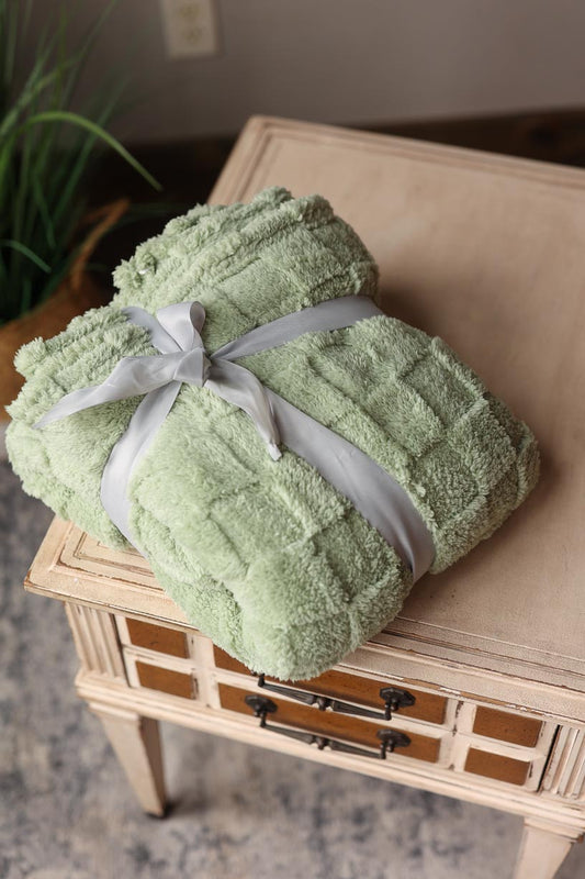 Snuggle up in style with our Sage Checkered Texture Plush Blanket! This unbelievably soft and incredibly cute throw blanket is the perfect addition to your cozy nights in. Whether it's for a gift or for yourself, the subtle sage color adds a touch of sophistication to any room. Classy Closet online women's clothing and gift boutique for everyday style, cute mom outfits, and modest fashion. Hull, Iowa