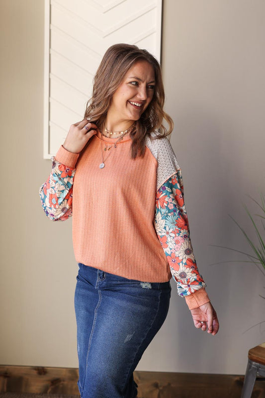 Add a pop of spring to your wardrobe with our Peach Floral Puff Sleeve Blouse! Perfect for work or brunch, the gorgeous color combo and floral pattern will make you happy. With a comfortable band at the bottom, you can easily style this top for any occasion.