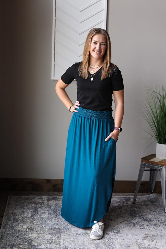 Experience adorable comfort with our Teal Smocked Waist Maxi Skirt! This cute and versatile skirt features a smocked waistband for a flattering fit and side slits for added style. Perfect for winter beach vacations or hot summer days, this skirt will keep you looking and feeling great all day long. Classy CLoset Online Skirt Boutique for Modest Women's Casual Clothing