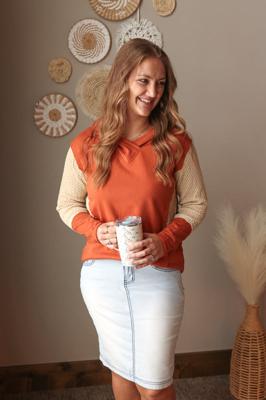 Chestnut orange colorblock sleeve v-neck hooded top styled for a cozy casual winter outfit