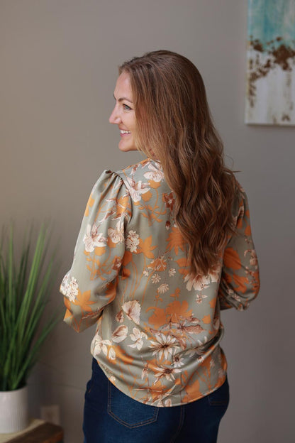 Elevate your wardrobe with this luxurious gray floral blouse! Made with dressy three-quarter sleeves, this silky top has a pretty fall floral print - ideal for everything from business meetings to special occasions and beyond. Feel confident and stylish in this top.