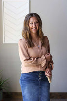 Elevate your wardrobe with this adorable Caramel Shirred Cuff Long Sleeve Blouse! This cute, lightweight V-neck blouse features chic, smocked ruffle cuffs that add a playful touch to any outfit. Perfect for office days with your favorite denim, special occasions like weddings and church, or a date night. So versatile, stylish, and comfortable.