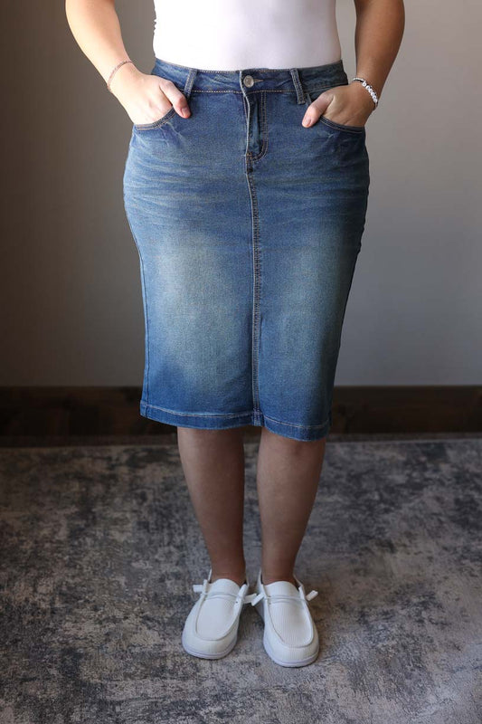 This vintage wash solid stretch midi denim skirt is the perfect way to take your look from drab to fab. Made with a durable and comfortable stretch denim that's perfect for long wear and multiple washes. You can easily pair this skirt with any basic top to make a cute, everyday outfit. Classy CLoset Hull Iowa women's skirts for modest dressing, modest skirts, jean skirts, hard to find denim skirts.