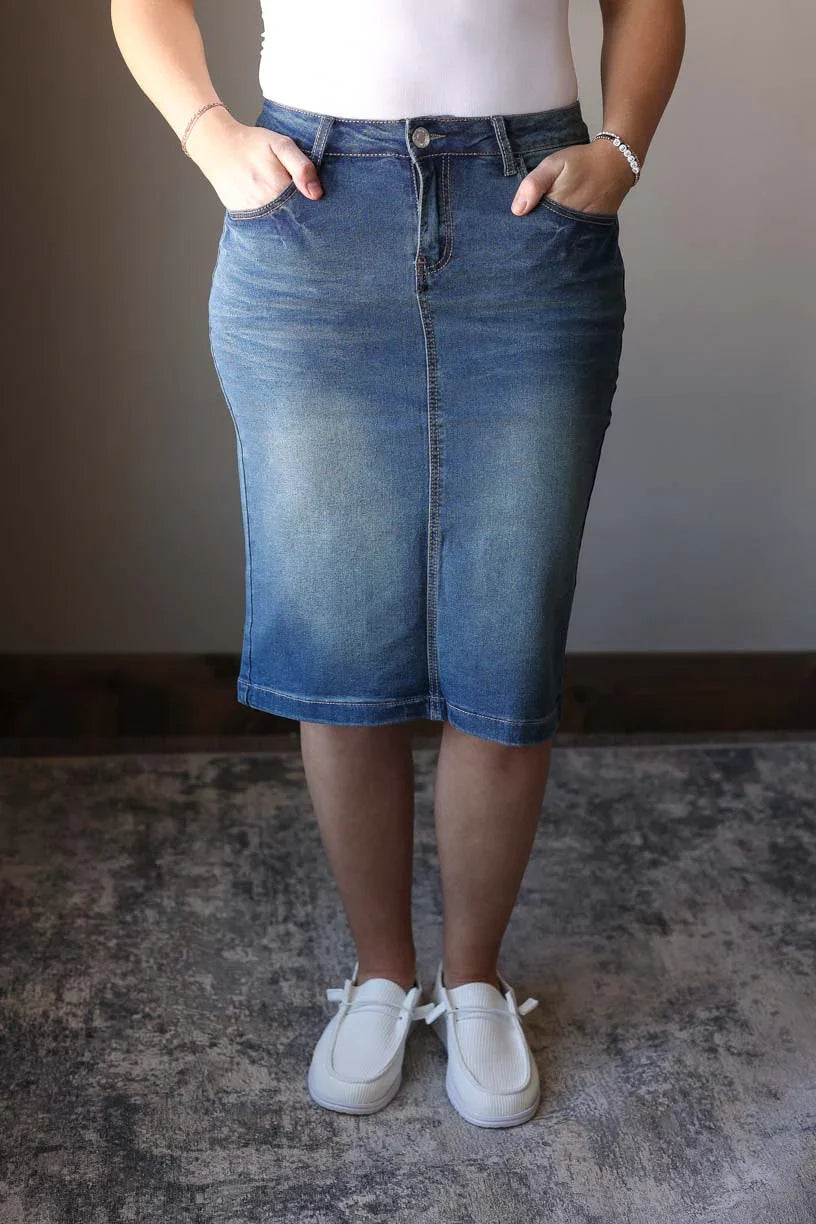 This vintage wash solid stretch midi denim skirt is the perfect way to take your look from drab to fab. Made with a durable and comfortable stretch denim that's perfect for long wear and multiple washes. You can easily pair this skirt with any basic top to make a cute, everyday outfit. Classy CLoset Hull Iowa women's skirts for modest dressing, modest skirts, jean skirts, hard to find denim skirts.