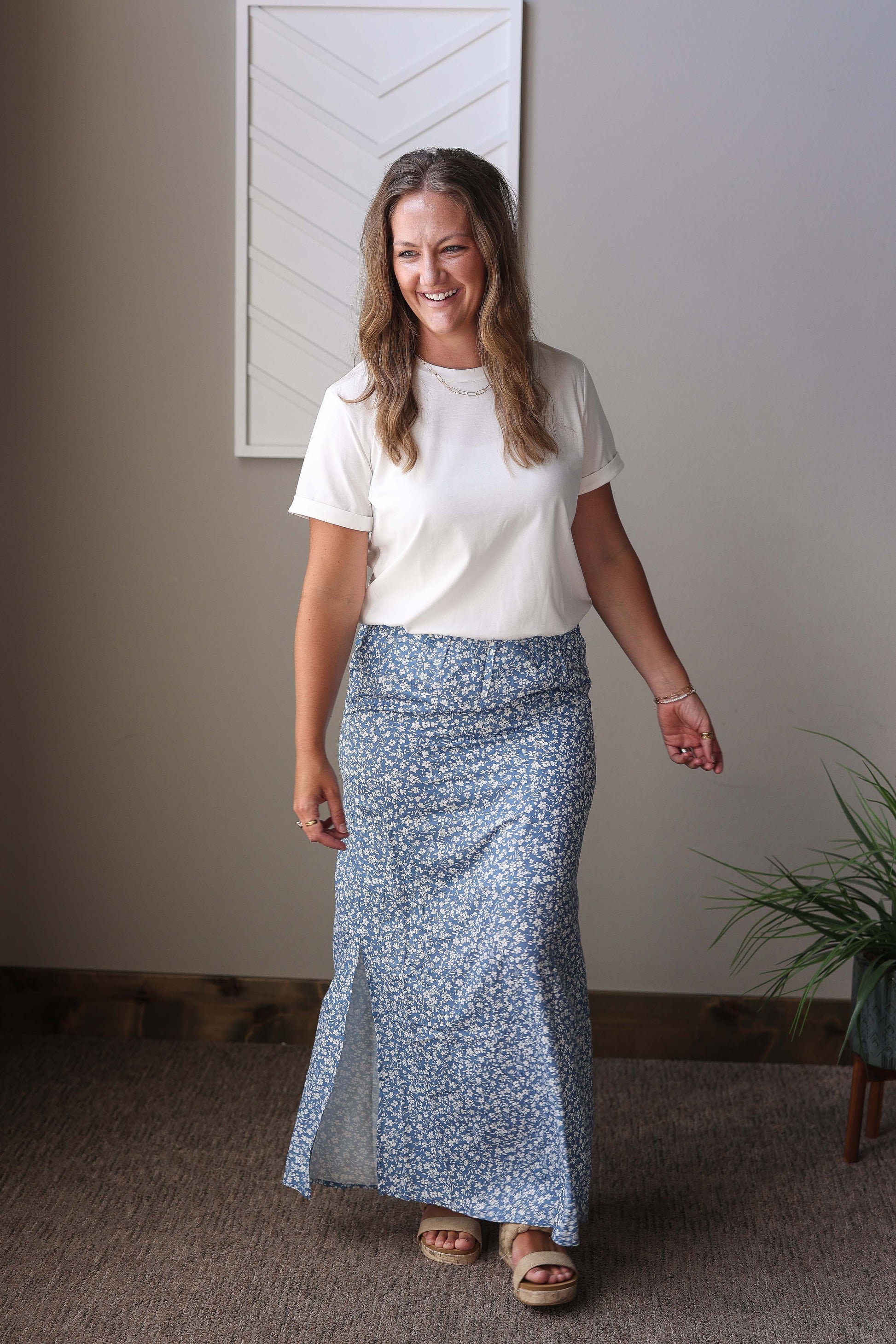 This sky blue boho maxi skirt features a fun, slimmer, a-line flow design that moves gracefully with you. The elastic waistband ensures a comfortable fit, while the side slit adds a playful touch. Perfect for sunny days and casual outings, its floral print brings a cheerful, carefree vibe to your wardrobe.