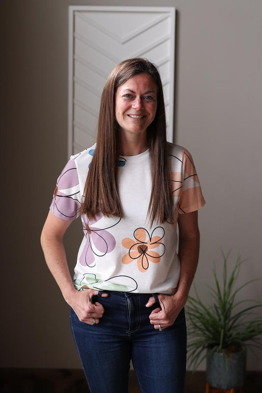 Get ready to bloom in the sun with our White Flower Print Top! This must-have summer staple in a cute white design with large open daisy prints, delivering effortless style for your everyday look. Perfect for keeping you cool and chic all season long. Classy Closet Trendy, Modest, Affordable Women's Clothing Shop Hull Iowa