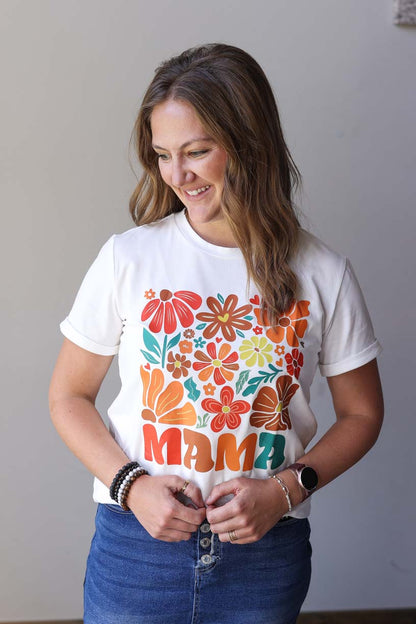 Brighten your mom wardrobe with this adorable white tee featuring a gorgeous floral "MAMA" graphic! The stylish rolled cuffs add a thoughtful touch to this easy-to-style essential. Perfect for playground dates, coffee runs, or simply embracing your mama status with a smile. Effortlessly pairs with your favorite denim or knit!